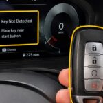 Car dashboard displaying a key not detected warning beside a key fob