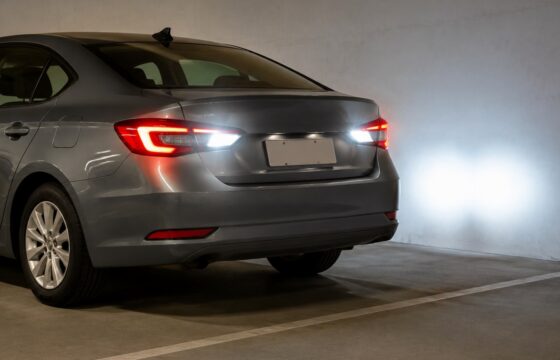 Car parked safely with both white reverse lights illuminated at the rear