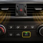 Vehicle climate-control panel set to A/C with warm air coming from the dashboard vents