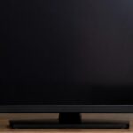 Smart TV with a lit standby indicator and a black screen