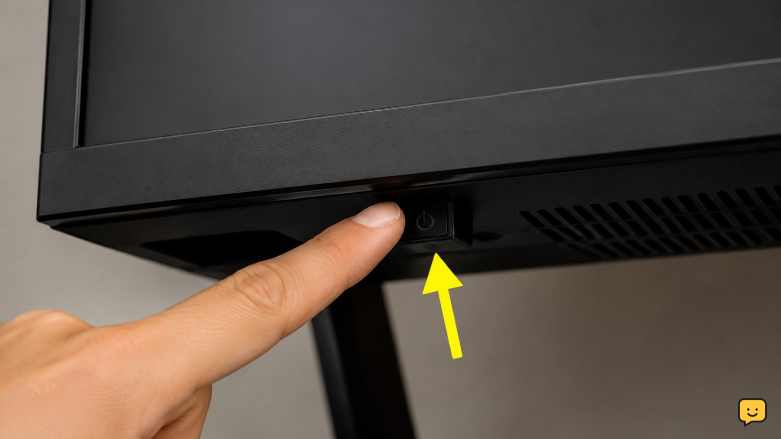 Close instructional view of a smart TV’s physical power button beneath the lower bezel